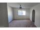 Spacious living room with carpeted floor and ceiling fan at 5124 W Onyx Ave, Glendale, AZ 85302