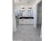 Modern bathroom with dual sink vanity, sleek marble floors, and glass enclosed shower at 5403 S 360 Th Ave, Tonopah, AZ 85354