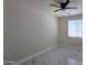 Bright bedroom with window, sleek marble floors, and modern ceiling fan at 5403 S 360 Th Ave, Tonopah, AZ 85354