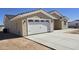 Single-story home features a concrete driveway and attached two-car garage at 5403 S 360 Th Ave, Tonopah, AZ 85354