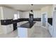 Spacious kitchen boasts white cabinetry, black backsplash, and a center island at 5403 S 360 Th Ave, Tonopah, AZ 85354