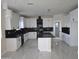 Modern kitchen with white cabinets, black countertops, and marble floors at 5403 S 360 Th Ave, Tonopah, AZ 85354