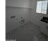 Laundry room with built-in cabinets and flooring at 5403 S 360 Th Ave, Tonopah, AZ 85354