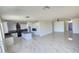 Open floor plan with a kitchen that features white cabinetry and black accents at 5403 S 360 Th Ave, Tonopah, AZ 85354