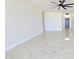 Spacious living room with sleek marble floors and a modern ceiling fan at 5403 S 360 Th Ave, Tonopah, AZ 85354