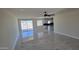 Open-concept living area with a ceiling fan, large sliding glass door, and kitchen at 5403 S 360 Th Ave, Tonopah, AZ 85354