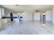 Spacious open floor plan flows into the kitchen featuring white cabinetry at 5403 S 360 Th Ave, Tonopah, AZ 85354