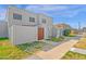 Front view of a light gray stucco townhome with a wooden gate and small front yard at 5406 W Hearn Rd, Glendale, AZ 85306