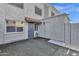 Private patio with gray stucco walls and a gray door at 5406 W Hearn Rd, Glendale, AZ 85306