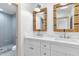 Bathroom with dual sinks, large mirrors, and a shower at 5720 E Marilyn Rd, Scottsdale, AZ 85254