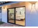 Bedroom with sliding glass doors leading to the outdoors, plush bedding, and soft lighting at 5720 E Marilyn Rd, Scottsdale, AZ 85254