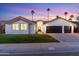 Stunning curb appeal featuring a two-car garage and well-manicured lawn at 5720 E Marilyn Rd, Scottsdale, AZ 85254