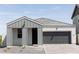 Gray exterior with a modern farmhouse design, two-car garage, and small front yard at 5830 S Daisy Patch Pl, Phoenix, AZ 85040