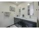 Bathroom features dual sinks, framed mirrors, a large glass block window and gray fixtures at 6366 N 19Th St, Phoenix, AZ 85016