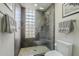 Tiled walk-in shower features glass door, glass block window, and a built-in shower caddy at 6366 N 19Th St, Phoenix, AZ 85016