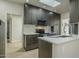 Modern kitchen with stainless appliances, dark wood cabinets and quartz countertops at 6366 N 19Th St, Phoenix, AZ 85016