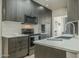 Sleek kitchen features stainless appliances, quartz countertops and dark wood cabinetry at 6366 N 19Th St, Phoenix, AZ 85016