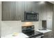 This kitchen features stainless steel appliances, white countertops, and wood look floors at 6366 N 19Th St, Phoenix, AZ 85016