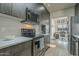 Modern kitchen with wood-look cabinets, stainless steel appliances, and adjacent office space at 6366 N 19Th St, Phoenix, AZ 85016