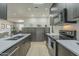 This kitchen features stainless steel appliances, white countertops, and wood look floors at 6366 N 19Th St, Phoenix, AZ 85016