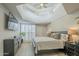 A bright primary bedroom with a tray ceiling and plantation shutters at 6366 N 19Th St, Phoenix, AZ 85016