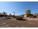 Large backyard with gravel, landscaping, and a shed at 6416 W Parkside Ln, Glendale, AZ 85310