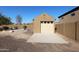 Detached garage with a large door and gravel at 6416 W Parkside Ln, Glendale, AZ 85310