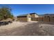 Backyard with shed, gravel, and a small citrus tree at 6416 W Parkside Ln, Glendale, AZ 85310