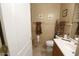 Bathroom with a toilet and wood vanity at 6416 W Parkside Ln, Glendale, AZ 85310