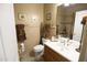 Bathroom with a toilet and wood vanity at 6416 W Parkside Ln, Glendale, AZ 85310