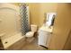 Clean bathroom with a shower/tub combo and vanity at 6416 W Parkside Ln, Glendale, AZ 85310