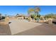 Long driveway leading to a tan house with landscaping at 6416 W Parkside Ln, Glendale, AZ 85310