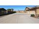 Long driveway and garage with rock landscaping at 6416 W Parkside Ln, Glendale, AZ 85310