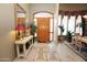 Entryway with decorative console table and wood door at 6416 W Parkside Ln, Glendale, AZ 85310