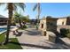 Stone fireplace in backyard patio area at 6416 W Parkside Ln, Glendale, AZ 85310