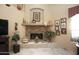 Living room with a stone fireplace and built-in shelving at 6416 W Parkside Ln, Glendale, AZ 85310