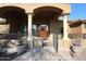 Covered entryway with arched columns and decorative iron gate at 6416 W Parkside Ln, Glendale, AZ 85310