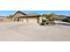 Two-car garage with large driveway and desert landscaping at 6416 W Parkside Ln, Glendale, AZ 85310