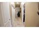 Bright hallway with tile flooring and access to multiple rooms at 6416 W Parkside Ln, Glendale, AZ 85310