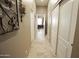 Long hallway with access to bedrooms and office at 6416 W Parkside Ln, Glendale, AZ 85310