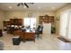 Spacious home office with built-in cabinetry and large desk at 6416 W Parkside Ln, Glendale, AZ 85310