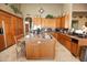 Open kitchen island with granite countertop and double sink at 6416 W Parkside Ln, Glendale, AZ 85310