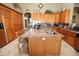 Island kitchen with granite countertops and wood cabinets at 6416 W Parkside Ln, Glendale, AZ 85310