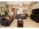 Living room with leather furniture and a ceiling fan at 6416 W Parkside Ln, Glendale, AZ 85310