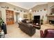 Spacious living area with leather sofas and a fireplace at 6416 W Parkside Ln, Glendale, AZ 85310