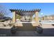 Outdoor kitchen with pergola and grill at 6416 W Parkside Ln, Glendale, AZ 85310