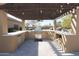 Covered outdoor kitchen with built-in appliances at 6416 W Parkside Ln, Glendale, AZ 85310