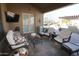 Comfortable outdoor living space with seating and a TV at 6416 W Parkside Ln, Glendale, AZ 85310