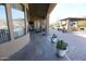 Covered patio with tile flooring and potted plants at 6416 W Parkside Ln, Glendale, AZ 85310