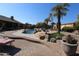 Stunning pool with a rock waterfall and plenty of seating around it at 6416 W Parkside Ln, Glendale, AZ 85310